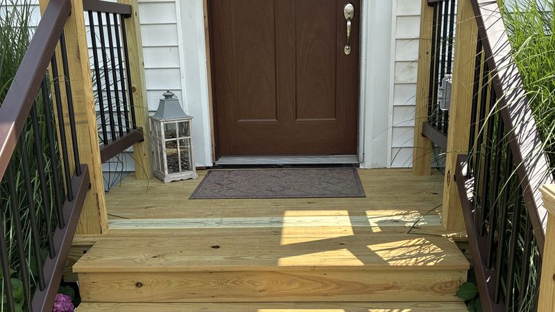 Rebuilt porch steps and railings — seasonal exterior maintenance